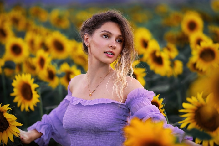Model in a sunflower field