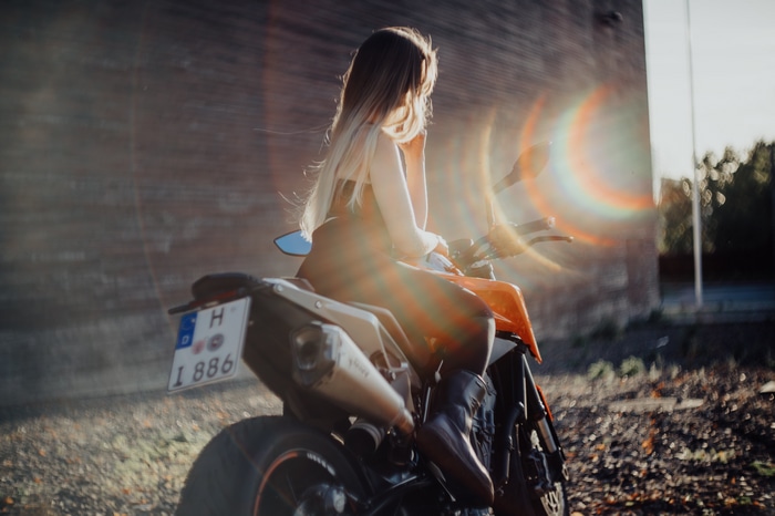Woman on a motorcycle with lens flare