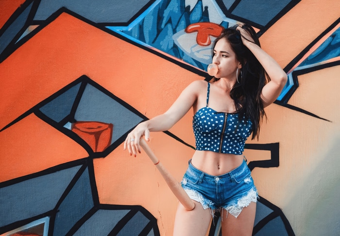 Girl with bubble gum and baseball bat