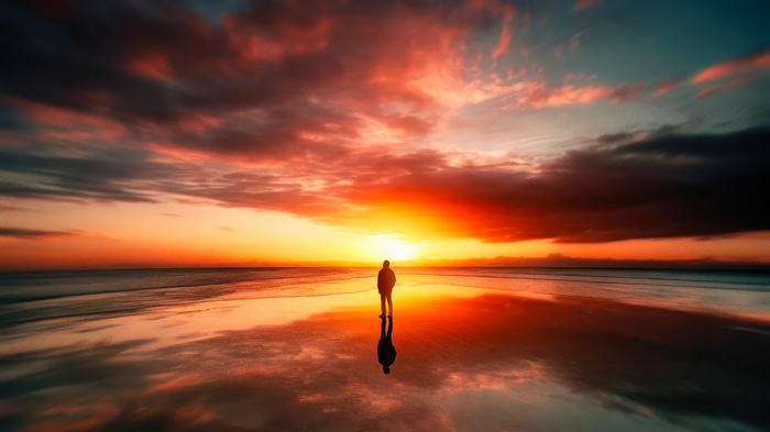 Man standing on beach during sunset 4K