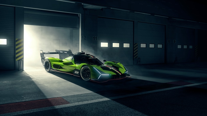 Green Lamborghini SC63 race car exiting garage