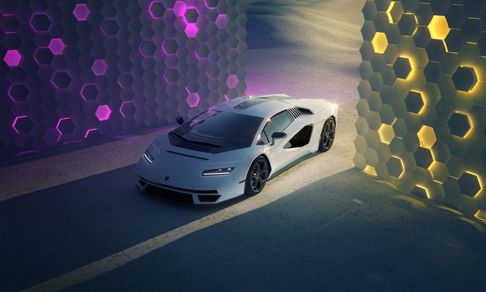White Lamborghini Countach on a road with hexagonal walls