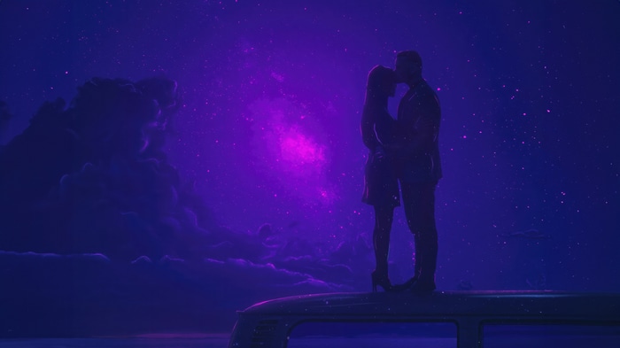 Couple kissing under a starry purple sky