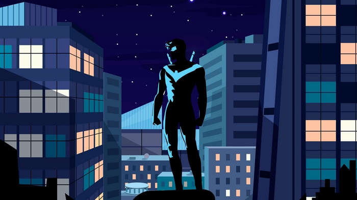 Nightwing standing on a rooftop at night