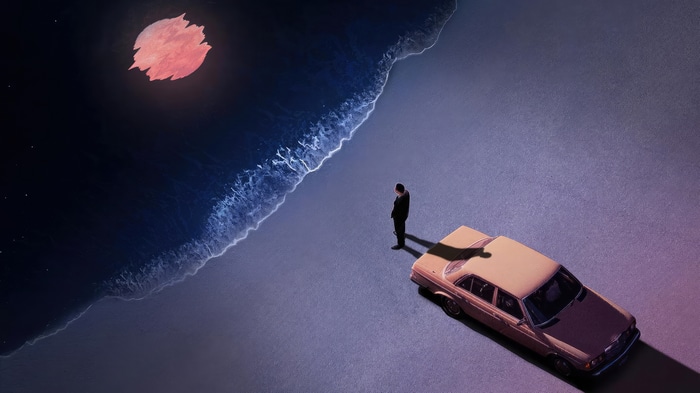 Man and car on a beach under a red moon