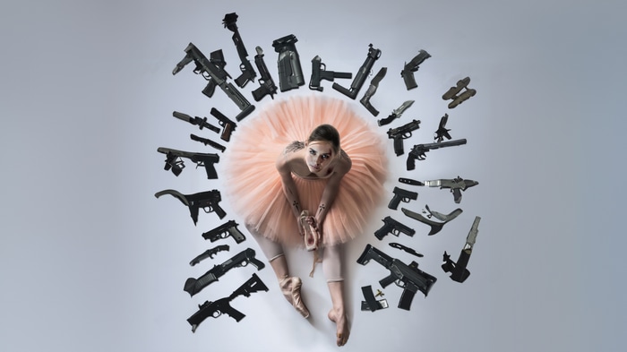 Ballerina surrounded by guns
