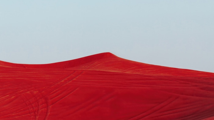 Red sand dunes under a clear sky