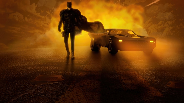The Batman and his Batmobile in a fiery scene