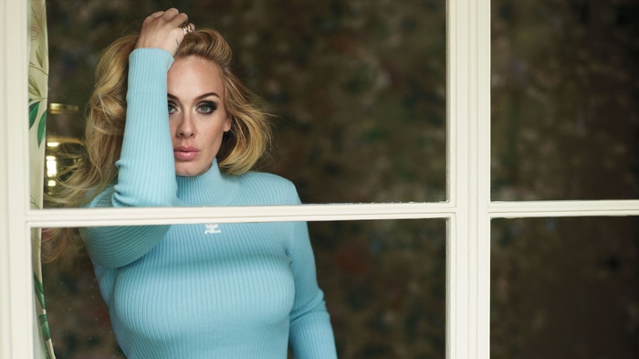 Adele wearing a blue turtleneck sweater