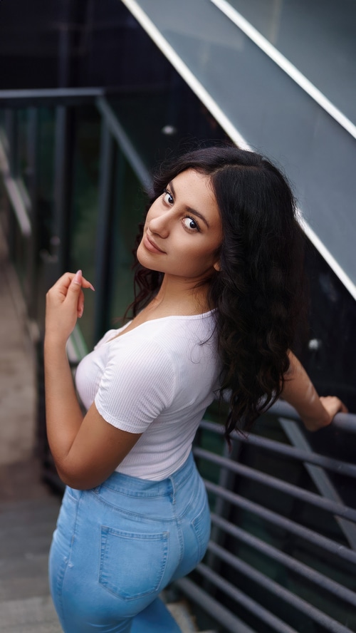 Young woman in white top and blue jeans
