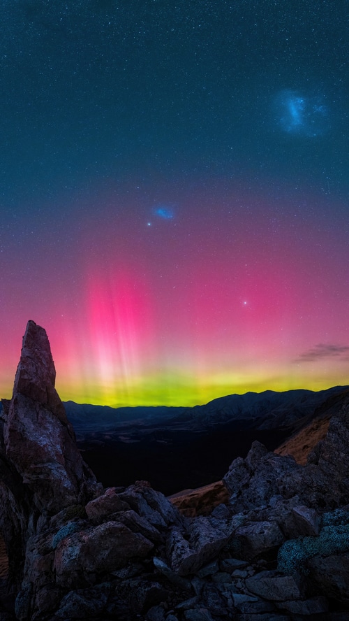 Aurora Borealis over mountains and rocks