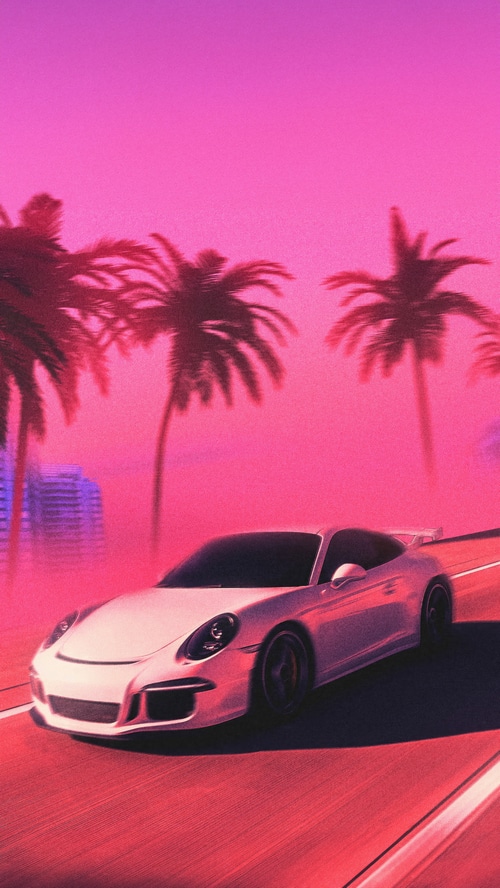 Porsche driving on a road with palm trees