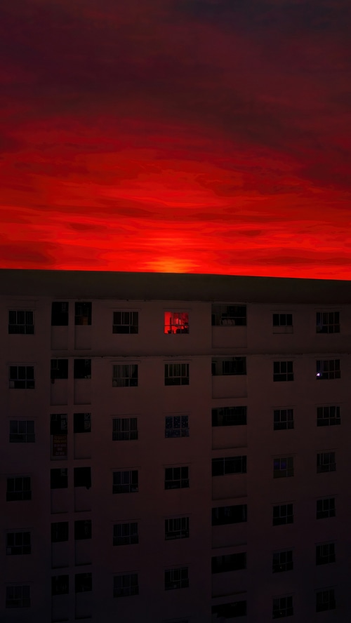 Red sky over apartment building at dusk