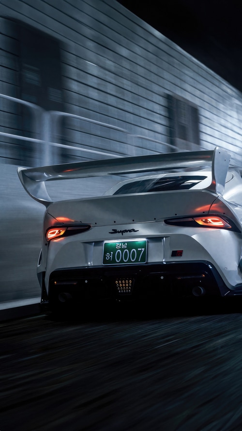 White Toyota Supra with a large rear spoiler