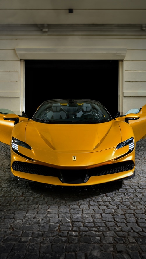 Yellow Ferrari SF90 Spider parked in a garage