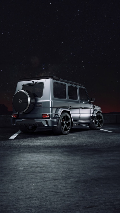 Mercedes G-Class SUV parked under a starry night sky