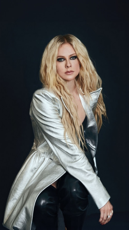 Avril Lavigne in a silver jacket and black pants