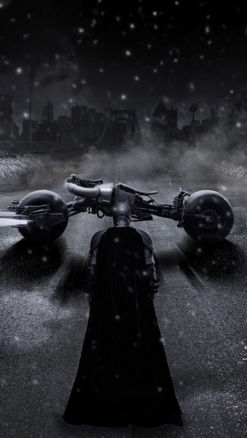 Batman and Batcycle in a snowy city