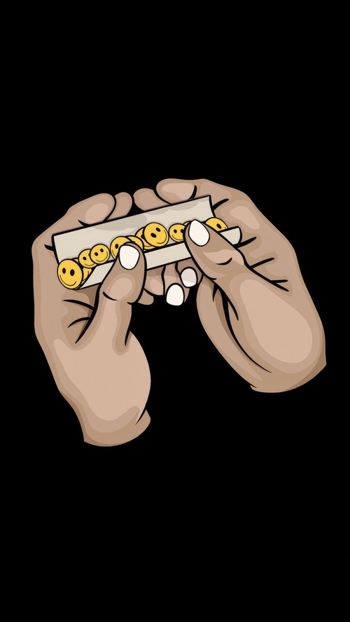 Hands rolling a cigarette with smiley faces