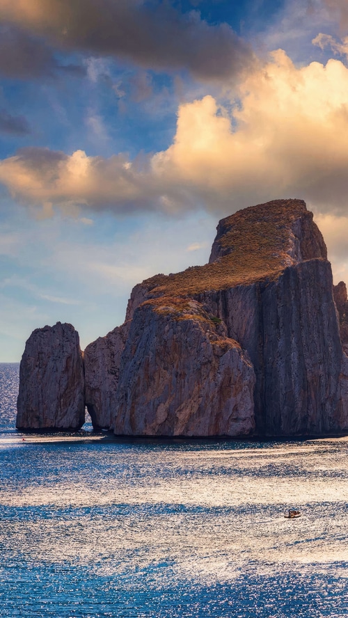 Rocky islands in the sea under a cloudy sky