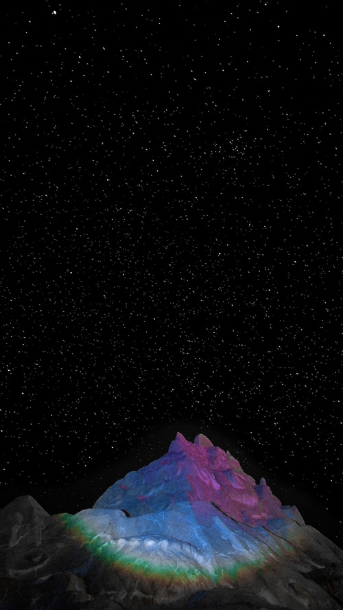 Mountain peak under a starry sky