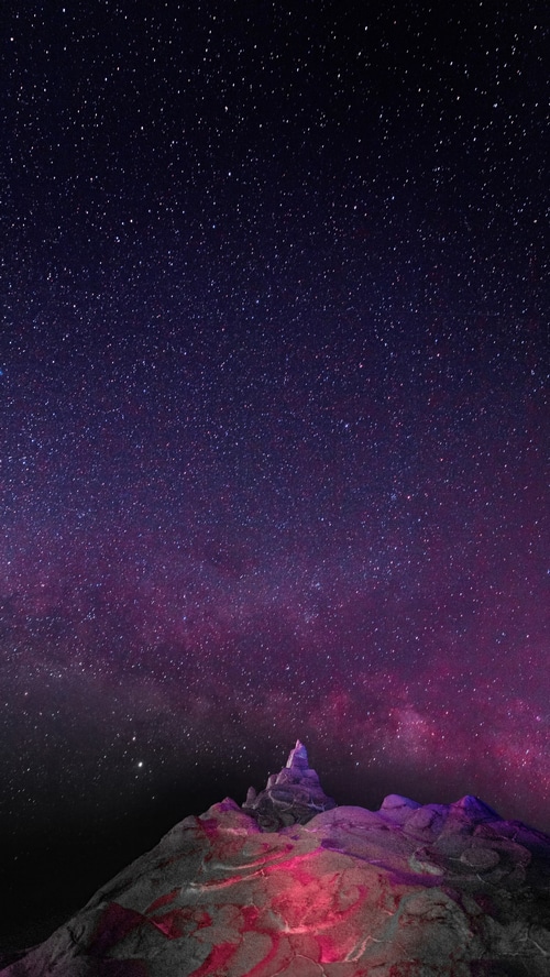 Mountain peak under a starry night sky