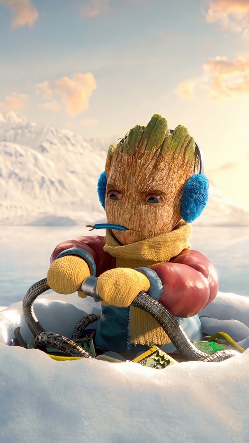 Baby Groot in winter clothes holding a controller