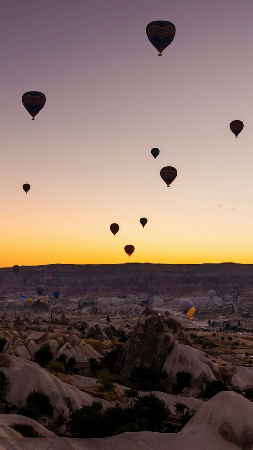 Hot air balloons over Cappadocia at sunrise