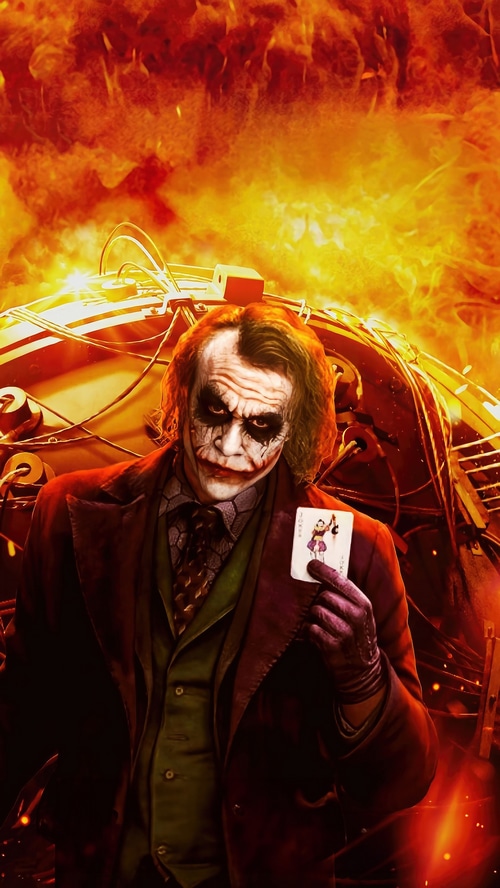 The Joker holding a playing card with fire in the background