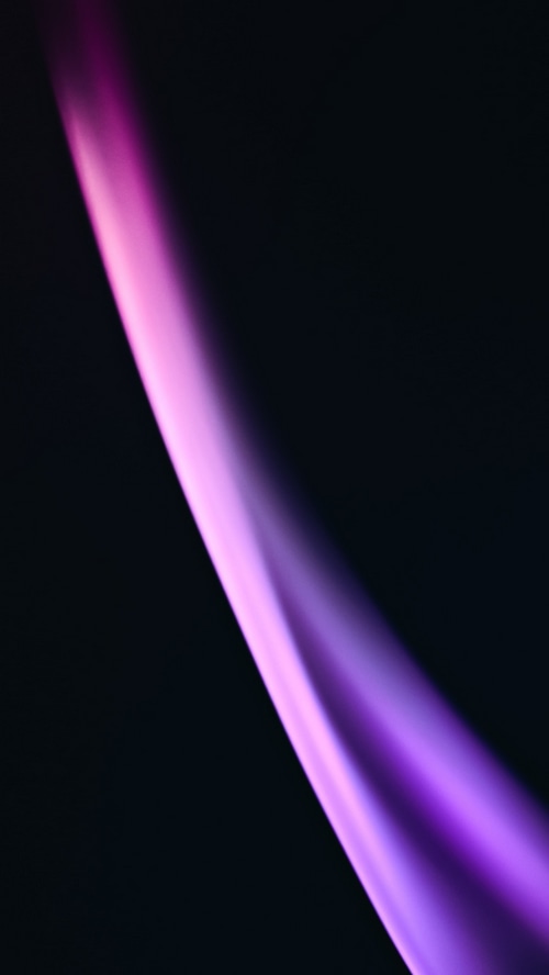 Abstract purple and pink light streaks on black background