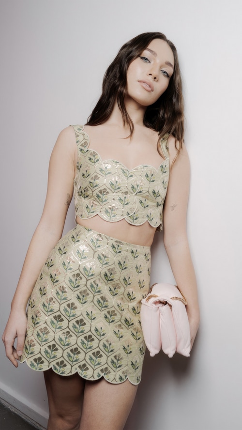 Maddie Ziegler in a floral crop top and skirt