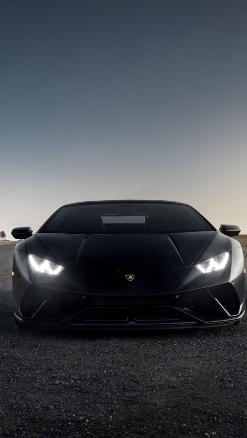 Black Lamborghini Huracan parked on a gravel road