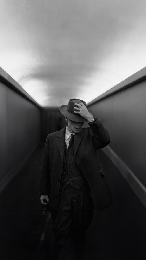Cillian Murphy as Oppenheimer in a hallway