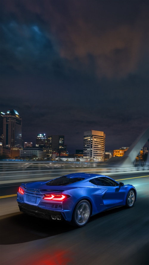 Blue Chevrolet Corvette E-Ray driving at night