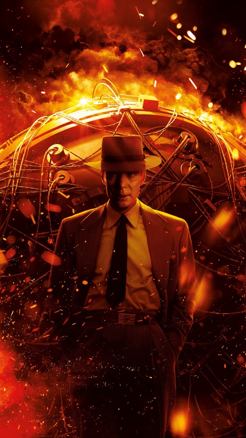 Oppenheimer standing in front of a large spherical device
