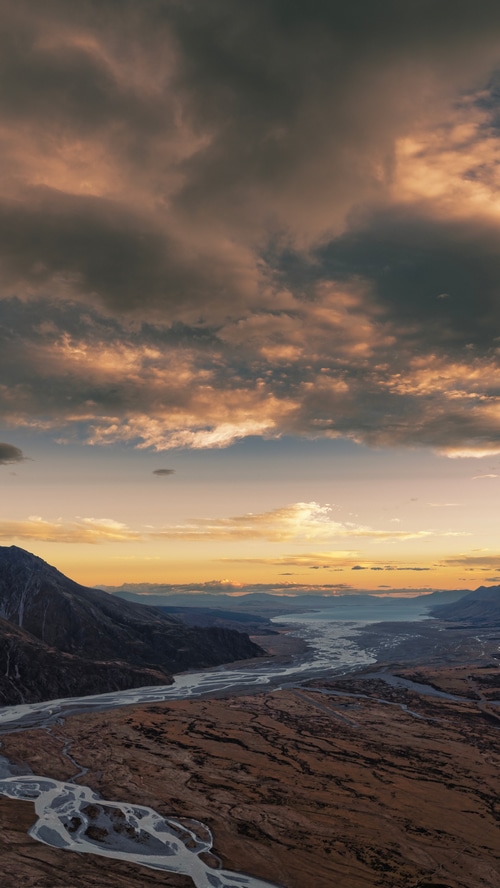 River valley and mountains under dramatic clouds