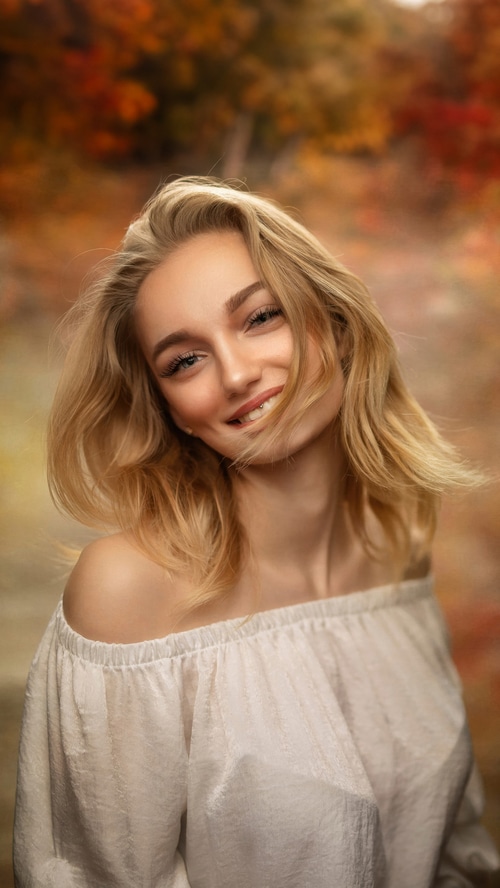 Blonde girl smiling in autumn