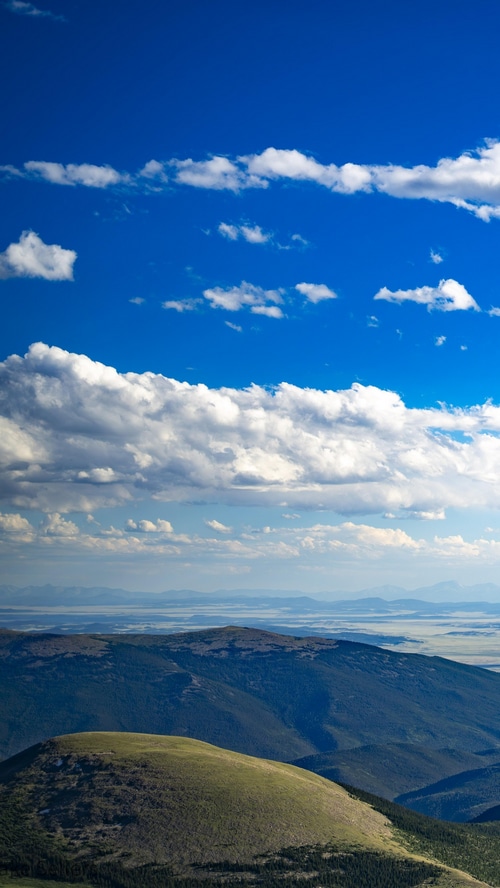 Mountains and clouds under a blue sky