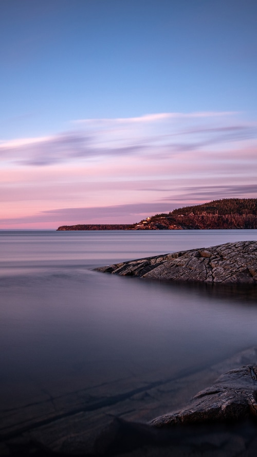 Ocean and rocky shore at sunset