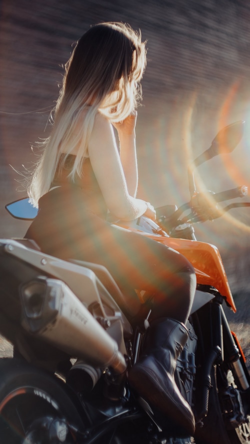 Girl on a motorcycle with lens flare
