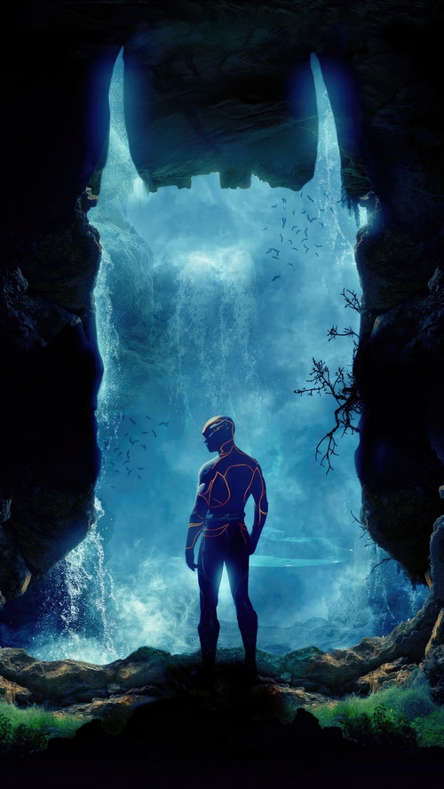 The Flash standing in a cave with a waterfall