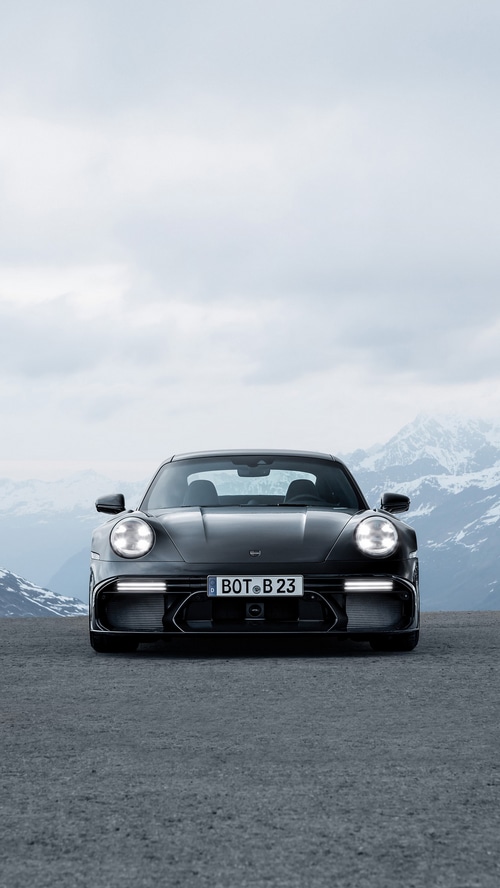 Black Porsche 911 with mountain background