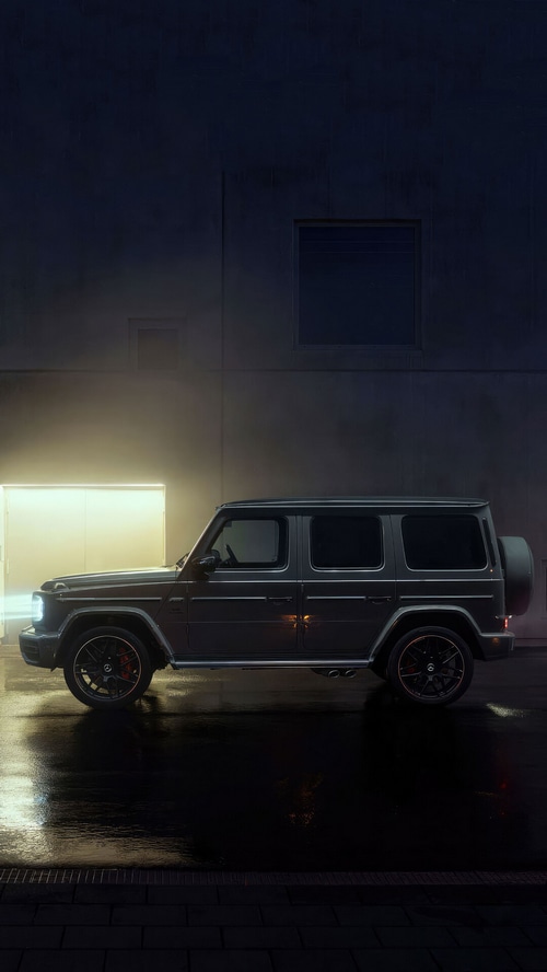 Mercedes-Benz G-Class SUV on wet street at night