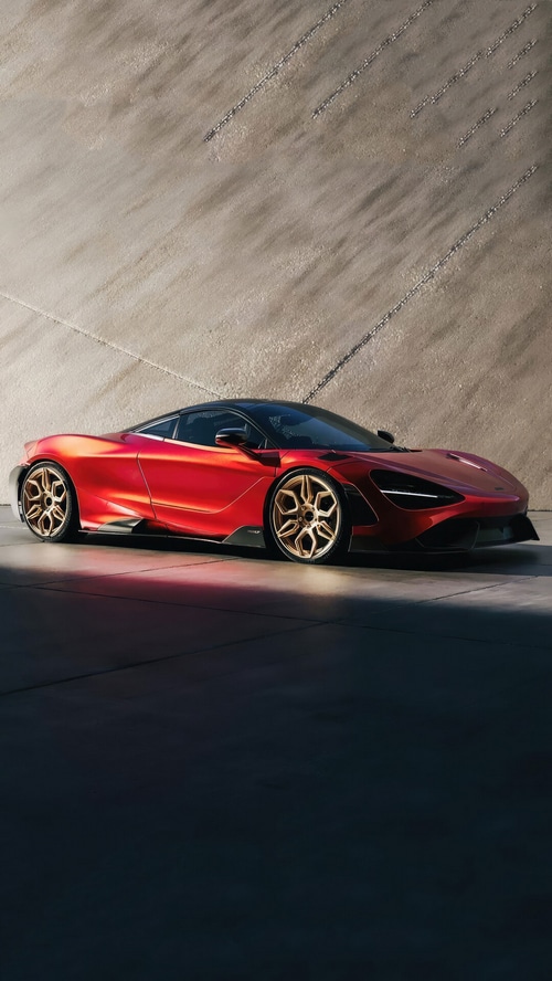 Red McLaren 765LT sports car with gold wheels