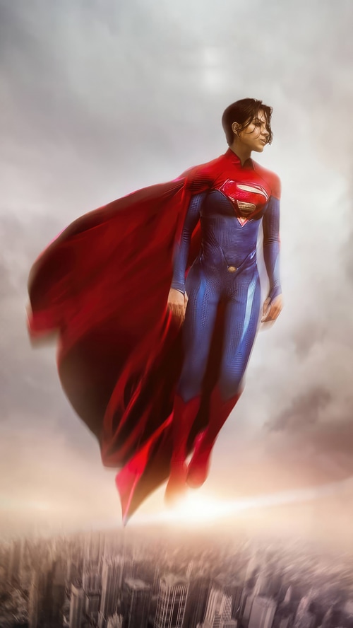 Supergirl flying over a city