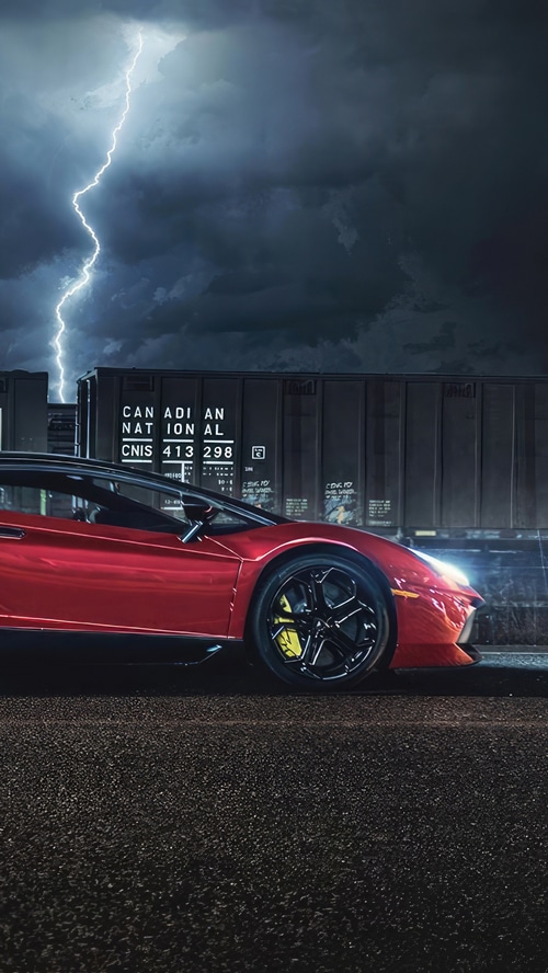 Red Lamborghini Aventador near Canadian National train