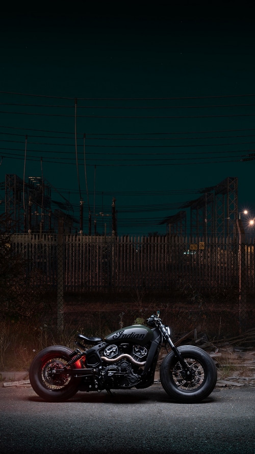 Indian Motorcycle parked at night near power lines
