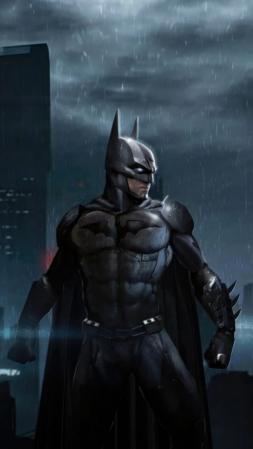 Batman standing in the rain at night