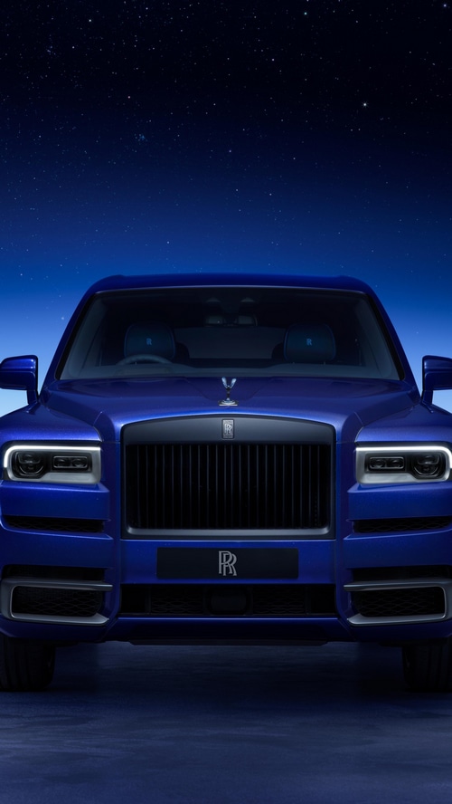 Rolls-Royce Cullinan parked under a starry night sky
