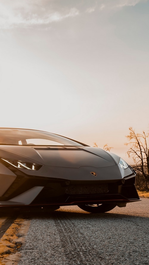 Lamborghini Huracan parked on a road at sunset